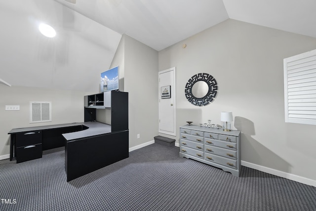 carpeted home office featuring lofted ceiling