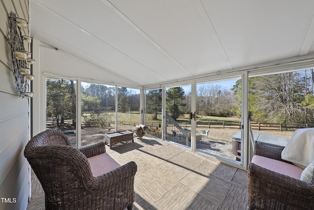 sunroom / solarium featuring a wealth of natural light and lofted ceiling