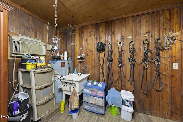 misc room featuring water heater, wooden ceiling, wood-type flooring, and wood walls