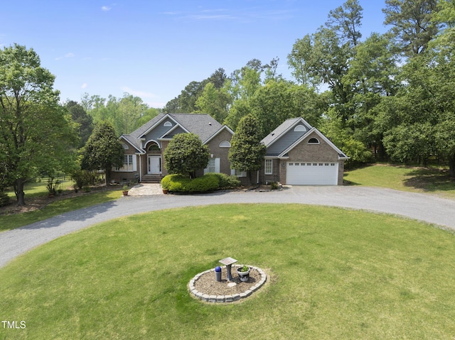 265 Verde Rd, Apex, NC 27523 - view of front facade with curved driveway, a front lawn, a garage, and brick siding