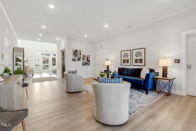 living room featuring light hardwood / wood-style floors and ornamental molding