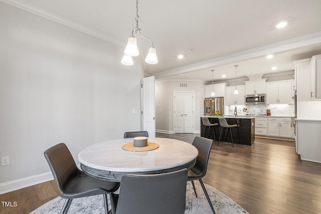 dining space with dark hardwood / wood-style flooring and ornamental molding