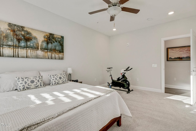 bedroom with ceiling fan and light carpet