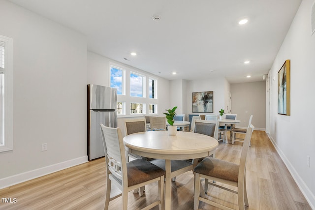 dining space with light wood-type flooring