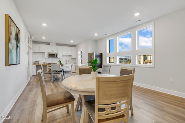 dining room with light hardwood / wood-style floors