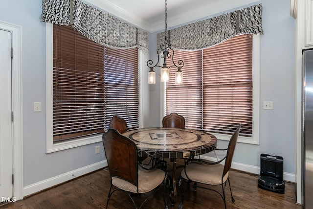 dining space with crown molding and dark hardwood / wood-style floors