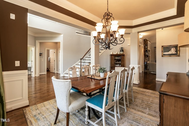 dining area with dark wood-type flooring, a chandelier, and crown molding