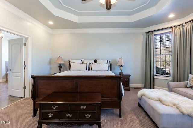 carpeted bedroom featuring ceiling fan, ornamental molding, and a tray ceiling