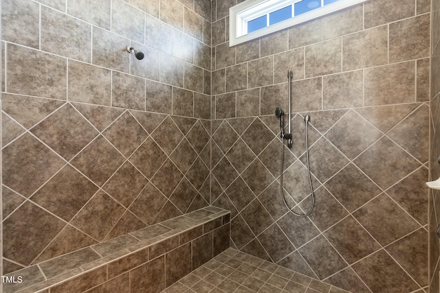 bathroom with a tile shower