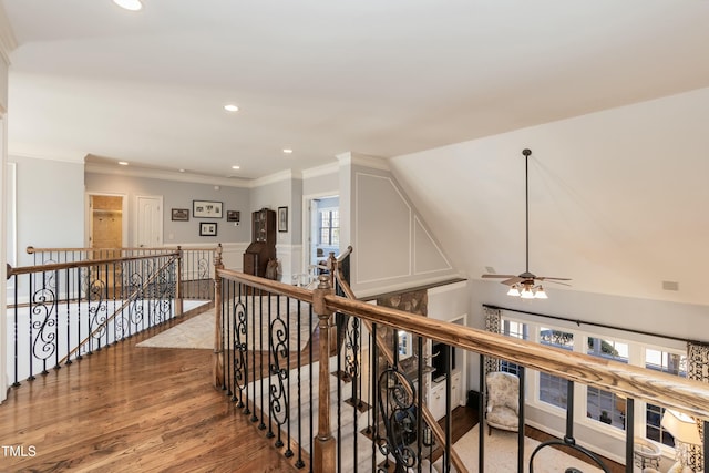 hallway featuring lofted ceiling, wood-type flooring, and crown molding