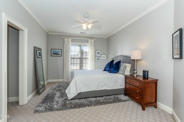 carpeted bedroom with ceiling fan and ornamental molding