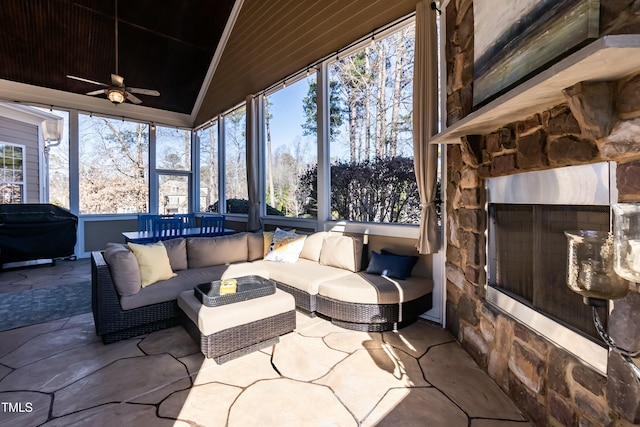 sunroom / solarium featuring lofted ceiling and ceiling fan