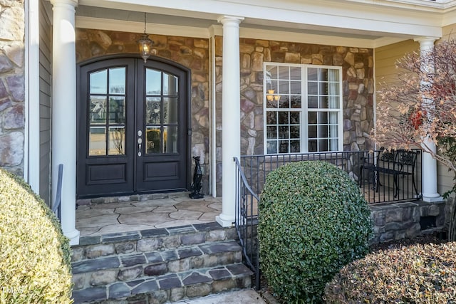 entrance to property featuring french doors and a porch