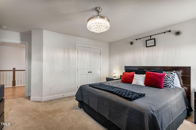 bedroom with carpet flooring, a notable chandelier, and a closet