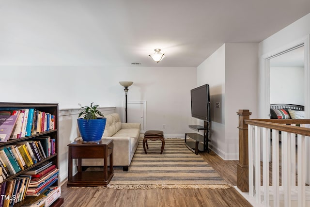 sitting room with wood-type flooring