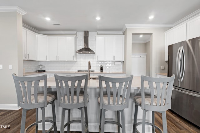 kitchen featuring white cabinetry, wall chimney exhaust hood, stainless steel appliances, and dark hardwood / wood-style floors