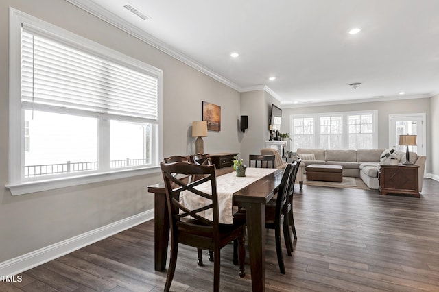 dining area featuring crown molding and dark wood-type flooring