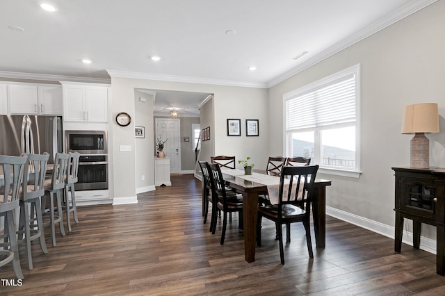 dining room featuring dark hardwood / wood-style flooring and ornamental molding