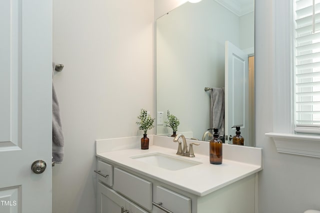 bathroom with crown molding and vanity