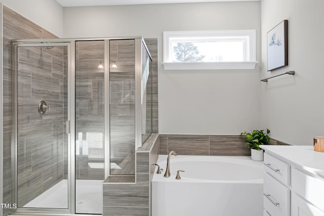 bathroom featuring separate shower and tub and vanity