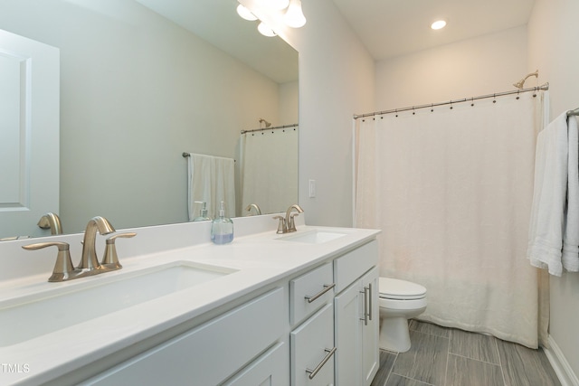 full bathroom featuring vanity, toilet, and shower / tub combo with curtain