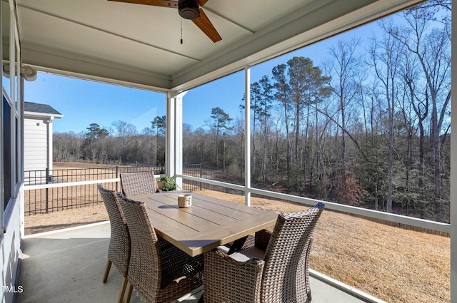 sunroom featuring ceiling fan