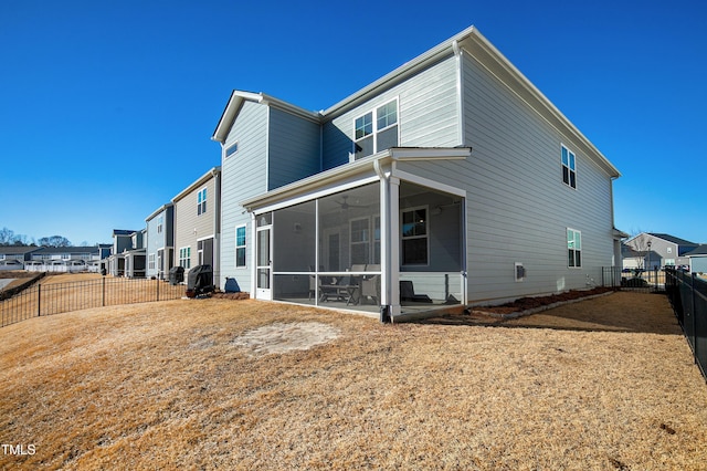 rear view of property featuring a sunroom