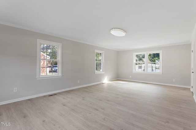 empty room with light wood-type flooring and ornamental molding