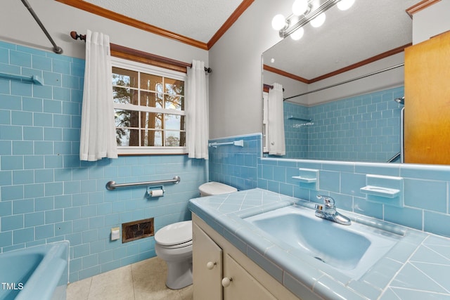 full bathroom with tile patterned floors, crown molding, a textured ceiling, vanity, and tile walls