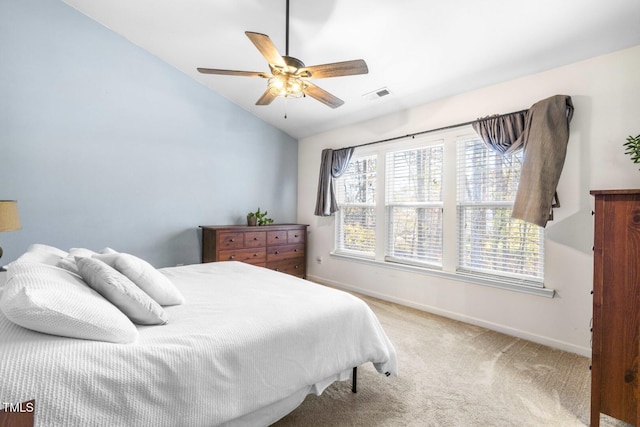 bedroom with vaulted ceiling, ceiling fan, and light carpet