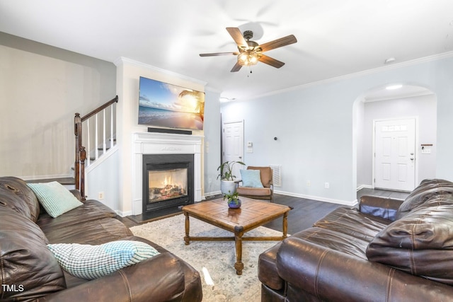 living room featuring ceiling fan, crown molding, and dark hardwood / wood-style floors