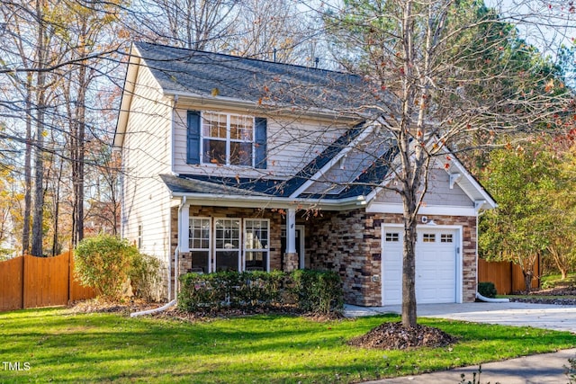 view of front of house with a front yard and a garage