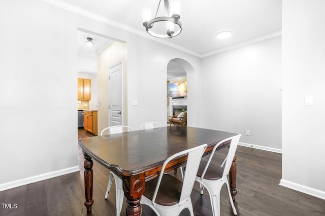 dining room featuring an inviting chandelier, crown molding, and dark hardwood / wood-style flooring