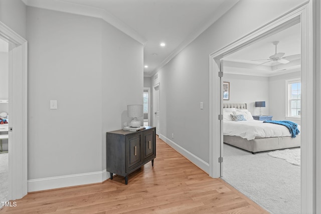 hall featuring light wood-type flooring and ornamental molding