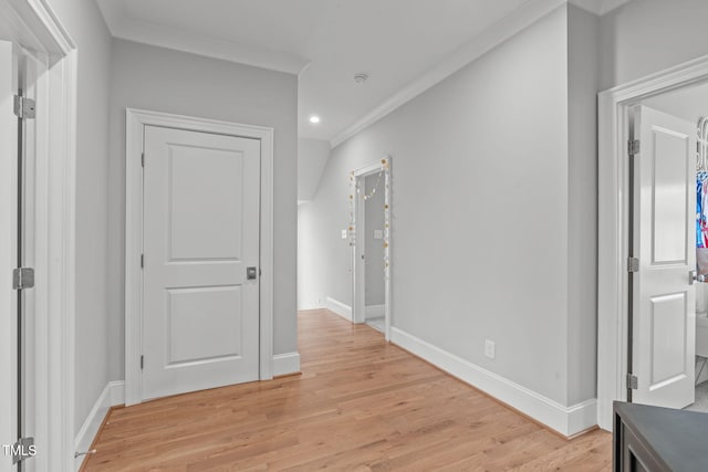 hall featuring light wood-type flooring and crown molding