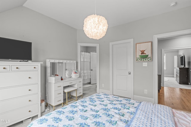 bedroom featuring light carpet and vaulted ceiling