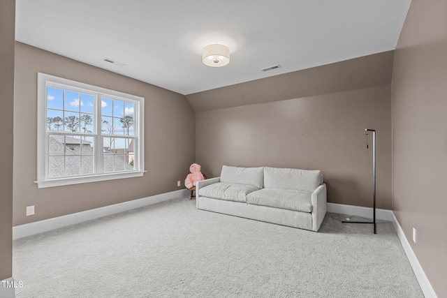 living area with lofted ceiling and carpet flooring