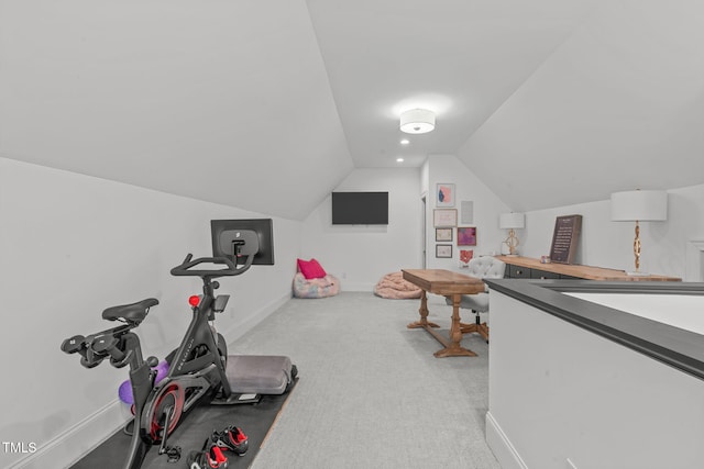 workout room with light colored carpet and vaulted ceiling