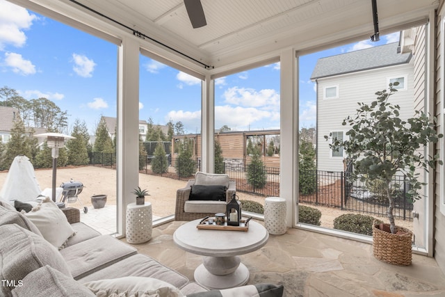 sunroom / solarium featuring ceiling fan