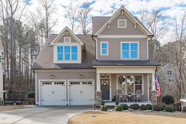 craftsman-style home with a garage and covered porch