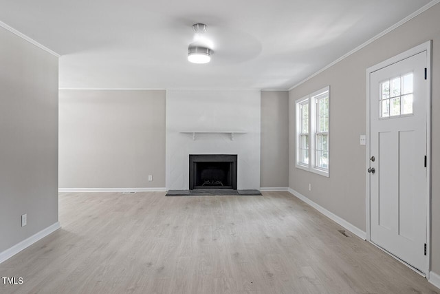 unfurnished living room featuring light hardwood / wood-style floors and ornamental molding