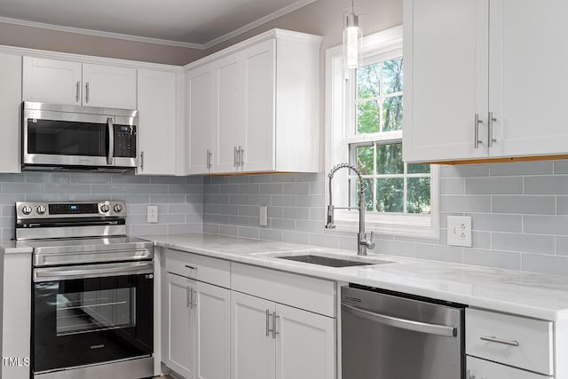 kitchen featuring decorative backsplash, sink, white cabinets, and stainless steel appliances