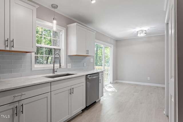 kitchen with white cabinetry, dishwasher, sink, light hardwood / wood-style flooring, and backsplash