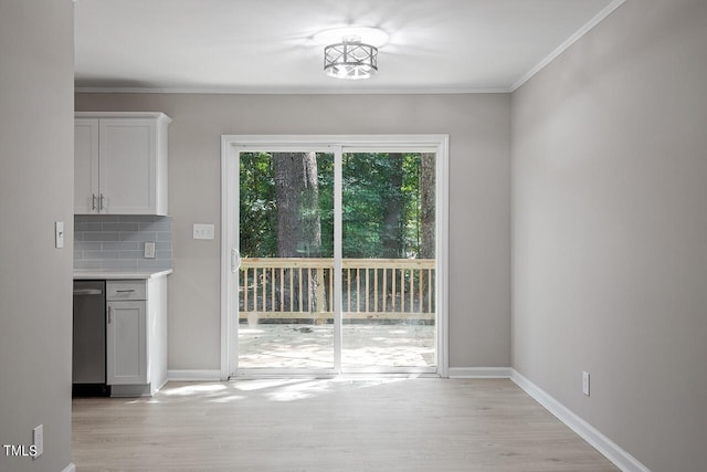 unfurnished dining area featuring ornamental molding and light wood-type flooring