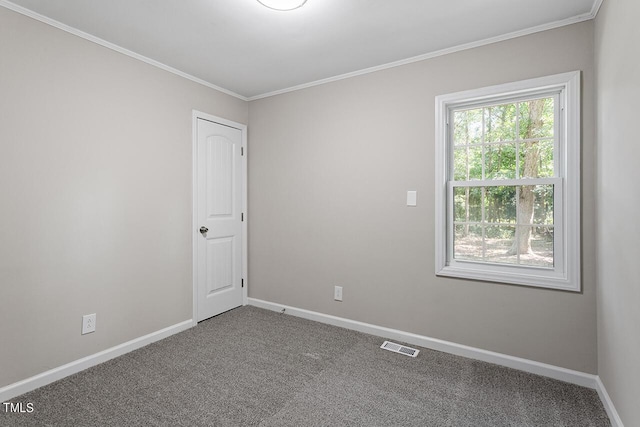 carpeted spare room featuring crown molding