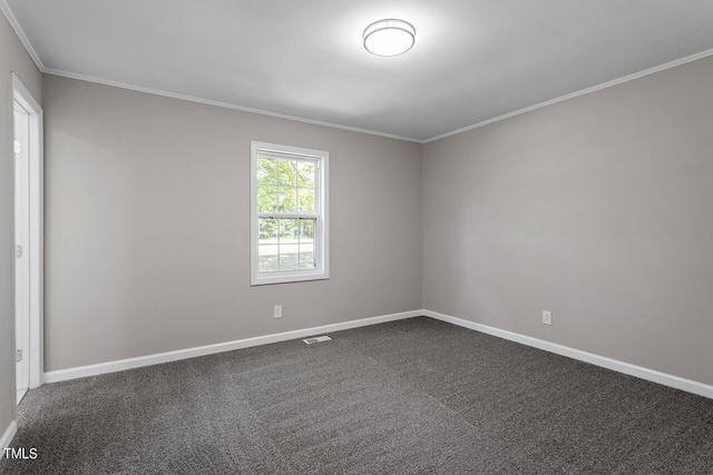 empty room featuring dark carpet and crown molding