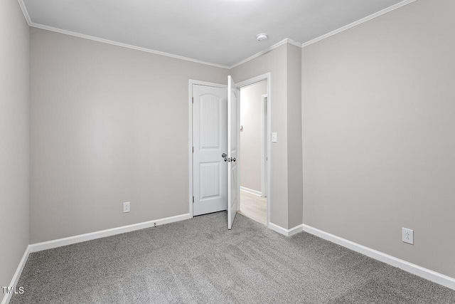 unfurnished bedroom featuring carpet flooring and crown molding