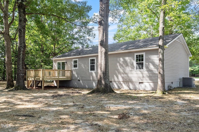 back of property featuring a wooden deck and central AC