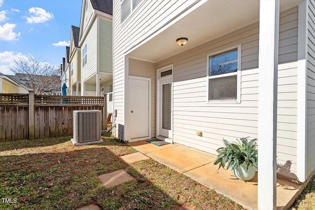 doorway to property with central air condition unit and a patio area