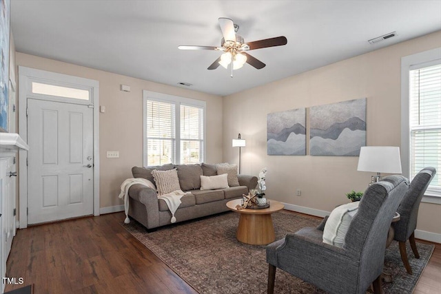 living room with ceiling fan and dark hardwood / wood-style flooring